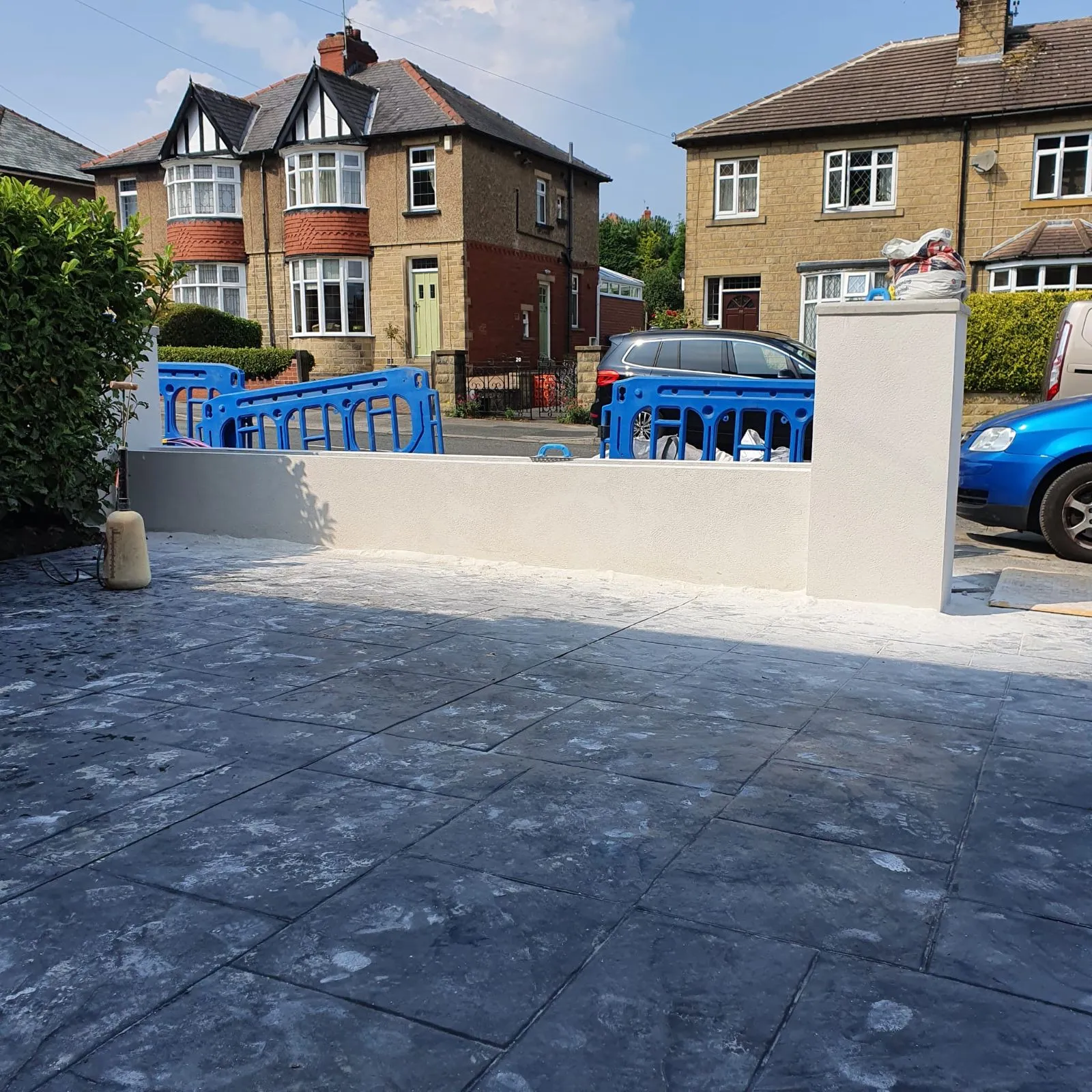 Front garden wall and pillars rendered white, with a new patio