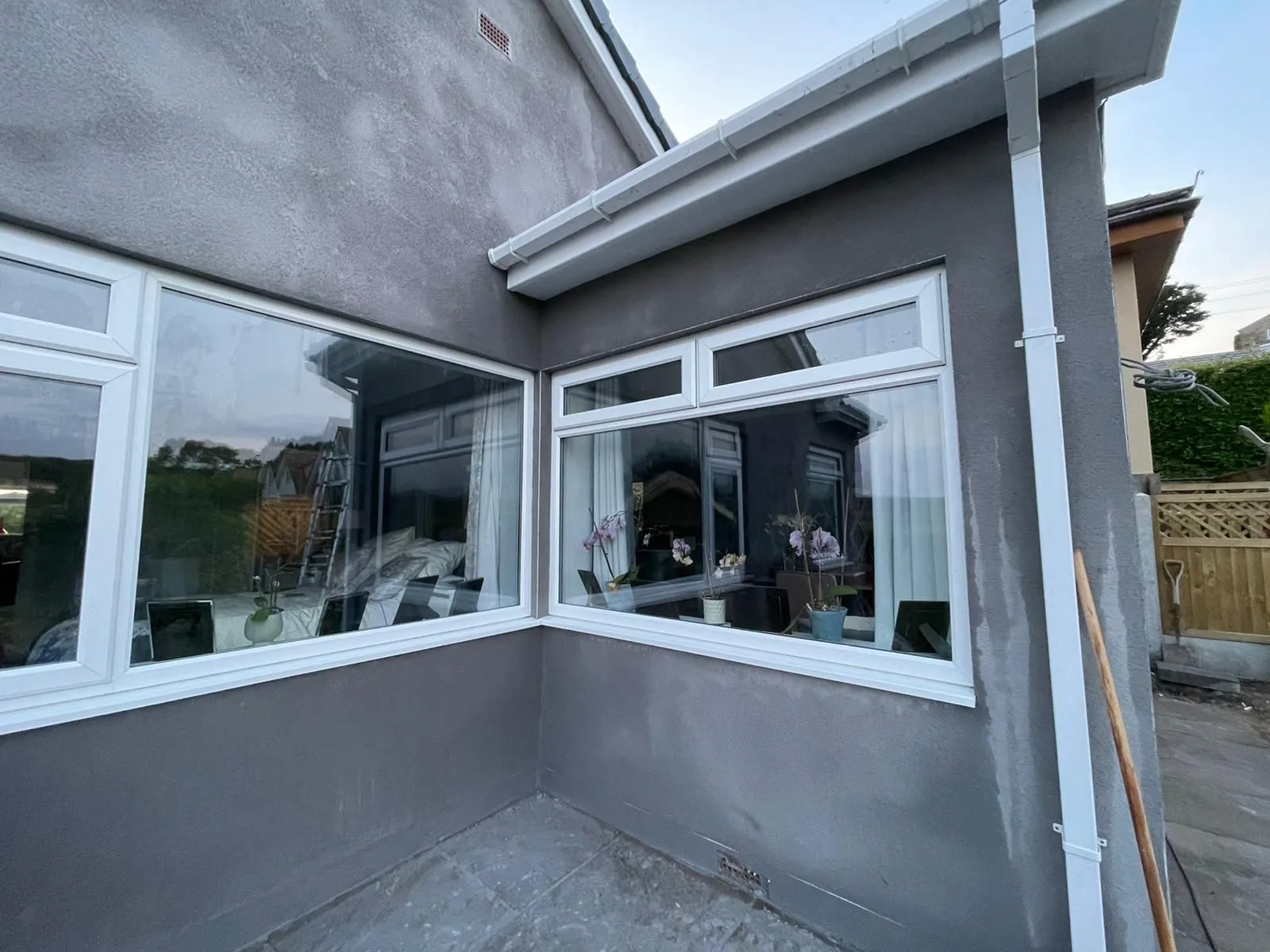 Bungalow corner freshly rendered in grey with white windows