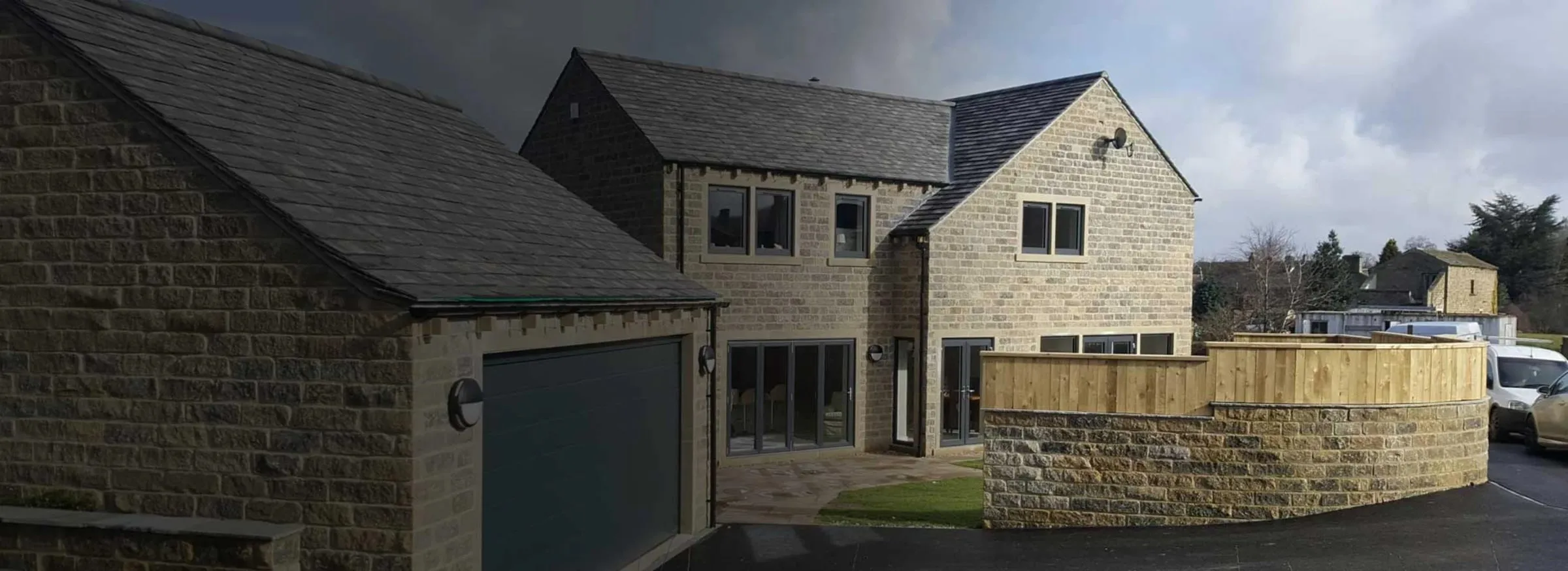 Stone-built detached house with slate roof and double garage